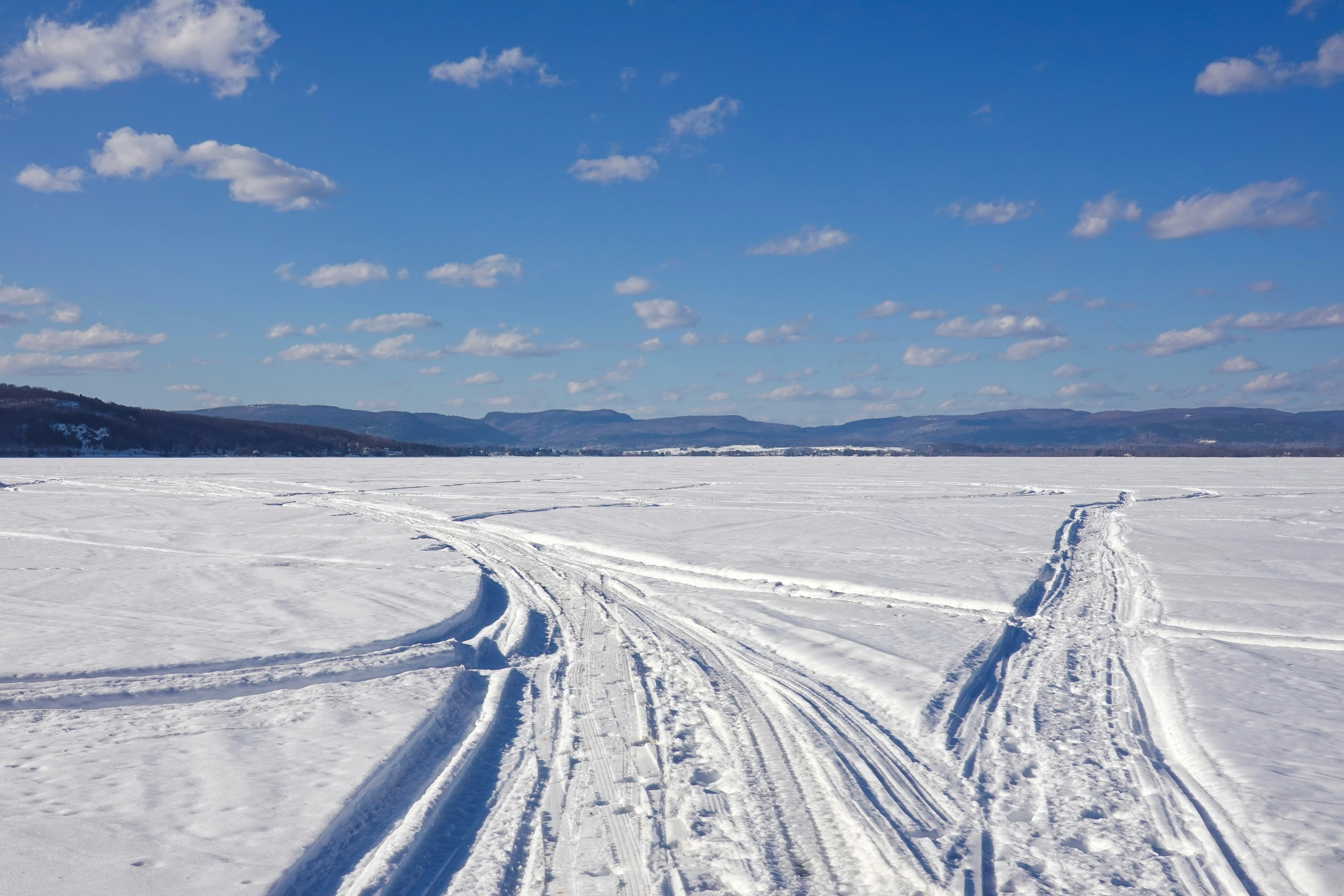 snow covered field under blue sky during daytime